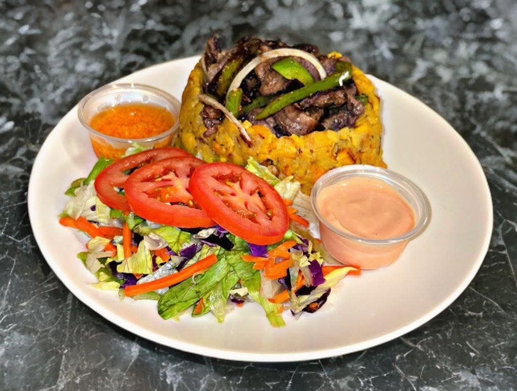 Bistec con mofongo — tender steak with garlicky mofongo, peppers, onions, and a fresh side salad at La Garita Restaurant